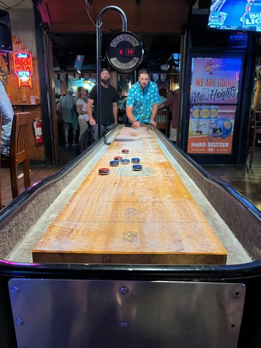 Shuffle board game table at Rooster's.