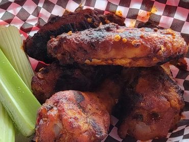 Fresh wings and great flavor in a basket with celery sticks.