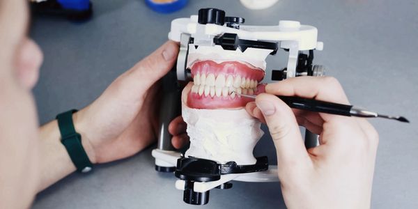 dental technician works with dental prostheses