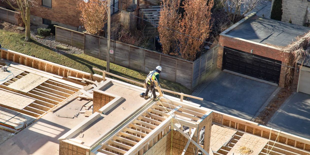 Construction worker on building roof.