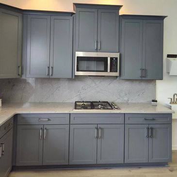 Cabinets in Graphite Color, Amazonite counters with full backsplash and stainless GE Appliances.