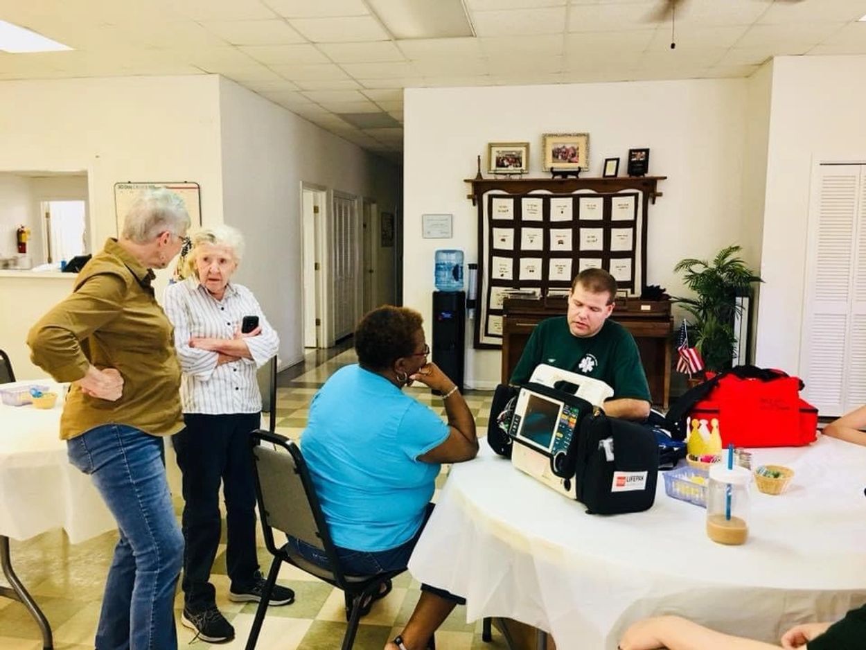 Dale EMS and Rescue Squad visiting with neighbors at the Newton Senior Citizen Center prior to COVID