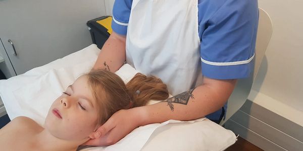 Alister Booth Osteopath treating a child with neck pain.
Relieving neck pain.