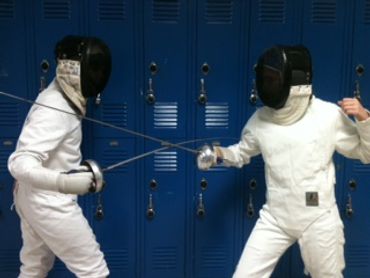 two fencers in front of school lockers