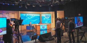 Inside a professional TV studio during a live talk show recording.
