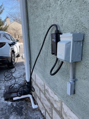 Weather resistant NEMA 14-50 EV rated receptacle with in-use cover for exterior Level 2 EV charging.