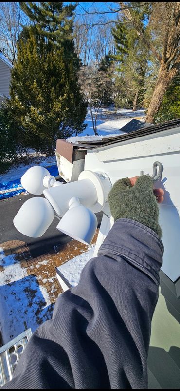 Exterior floodlight installation with secure mounting and weather rated wiring.