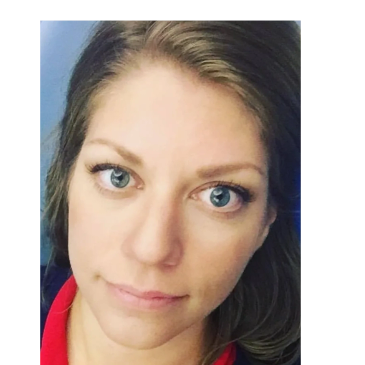 Close-up portrait of a woman with light eyes.