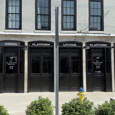 Facade of a vintage building with black doors labeled Platform, Dining, Lounge, and Events.