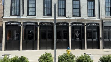 Facade of a vintage building with black doors labeled Platform, Dining, Lounge, and Events.