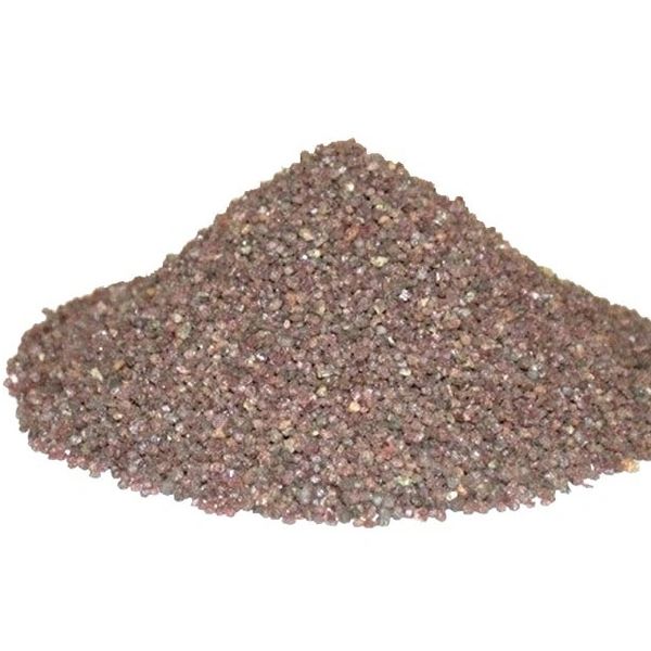 Pile of small reddish-brown granules on a white background.