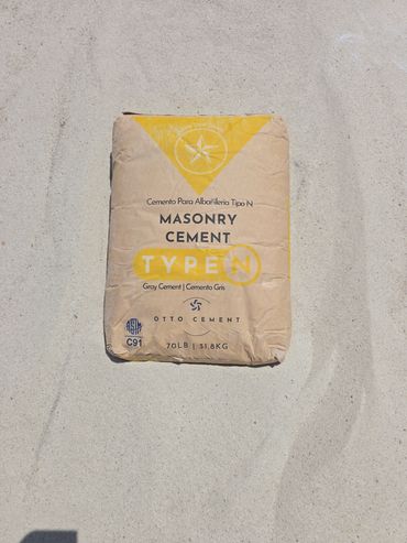 A bag of Type N masonry cement on sand.