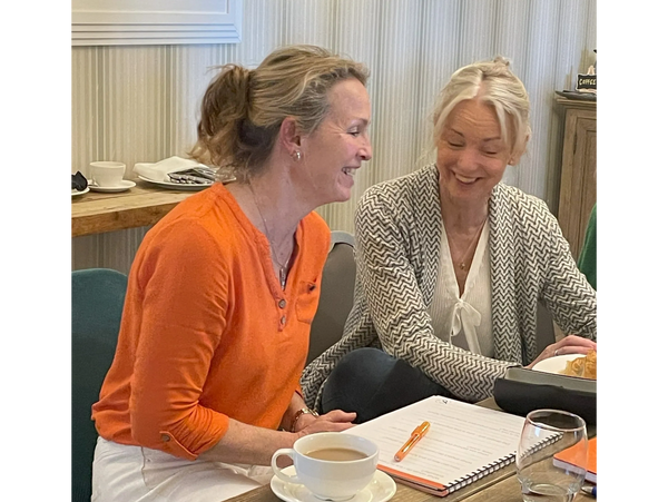 Sally laughing and smiling with a client during a workshop session
