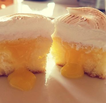 Tangy smooth Lemon Curd fills our tender vanilla bean cupcakes. They're finished with toasted marsh