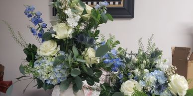 Two floral arrangements with white and blue flowers.