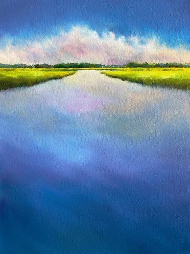 A serene river reflecting a vibrant sky with green fields on the horizon.