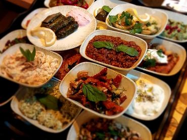 A variety of Mediterranean dishes served in small bowls and plates.