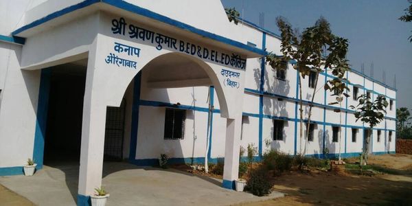 White and blue educational college building with Hindi signage.