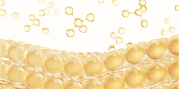 Golden spherical molecules floating above a layered surface of similar spheres.