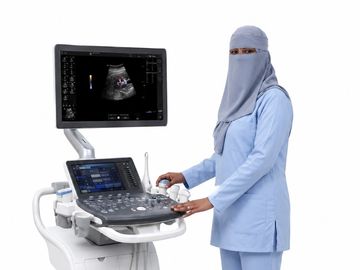 A woman in a niqab operating an ultrasound machine.