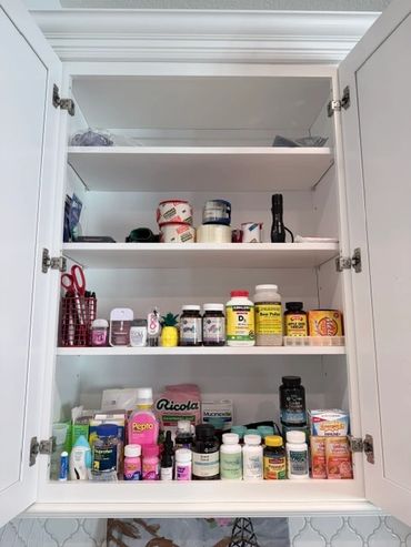Organized medicine cabinet with supplements and medications.