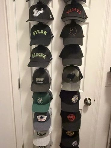After Declutter Zone organized the messy closet, they installed two vertical rows to organize the hats in the closet.
