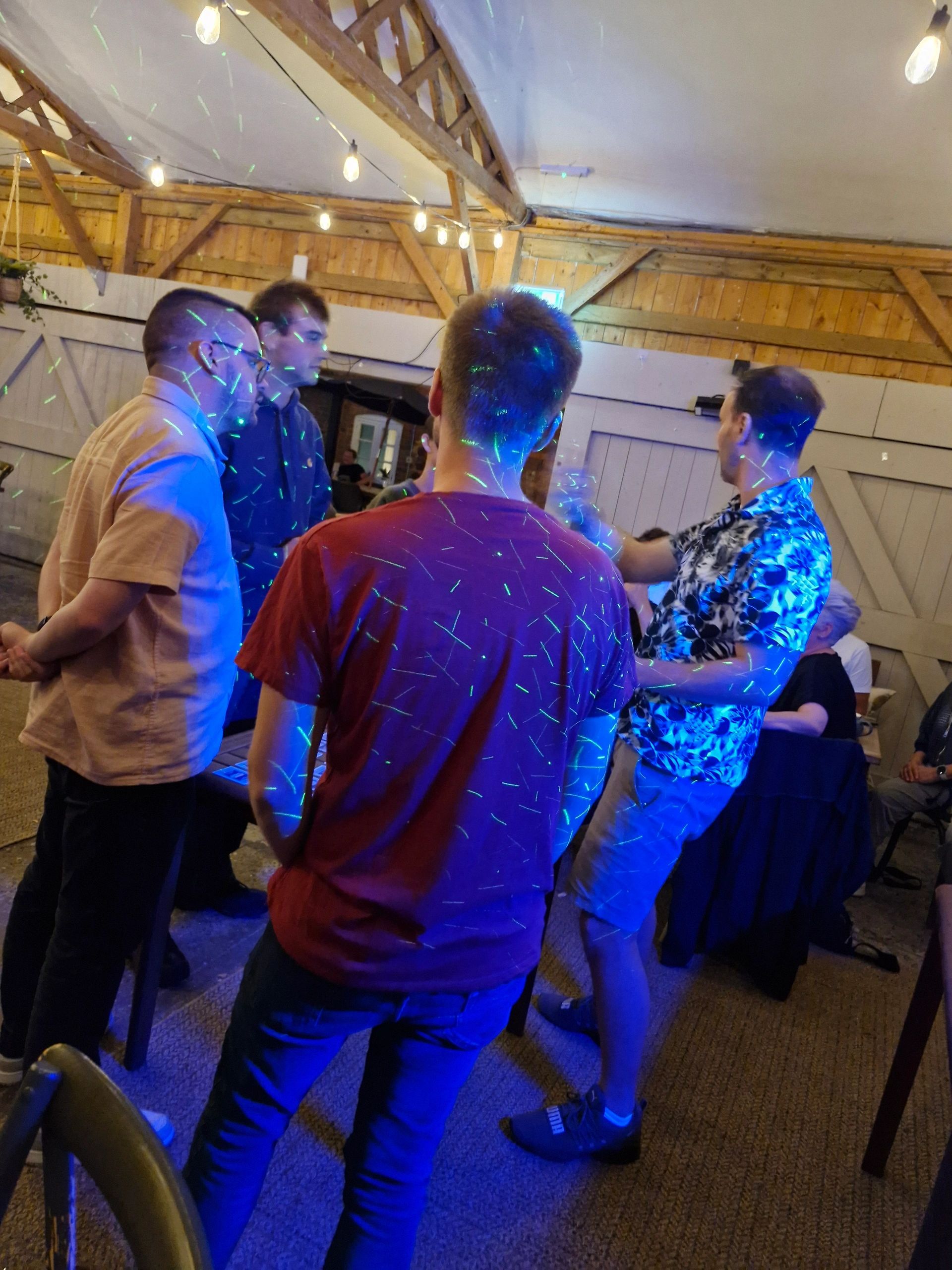 Stack of books next to pencils in a holder and a camera.