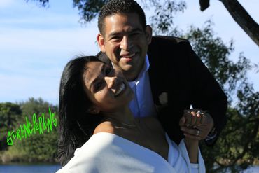 Beautiful Latino couple on their wedding day pose in sunlit Heritage Park, Plantation Florida .
