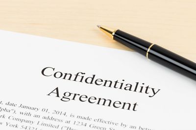 Confidentiality agreement and pen on a table
