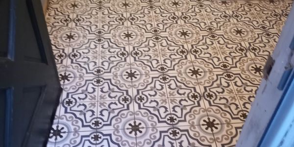 Patterned black and white tile floor.