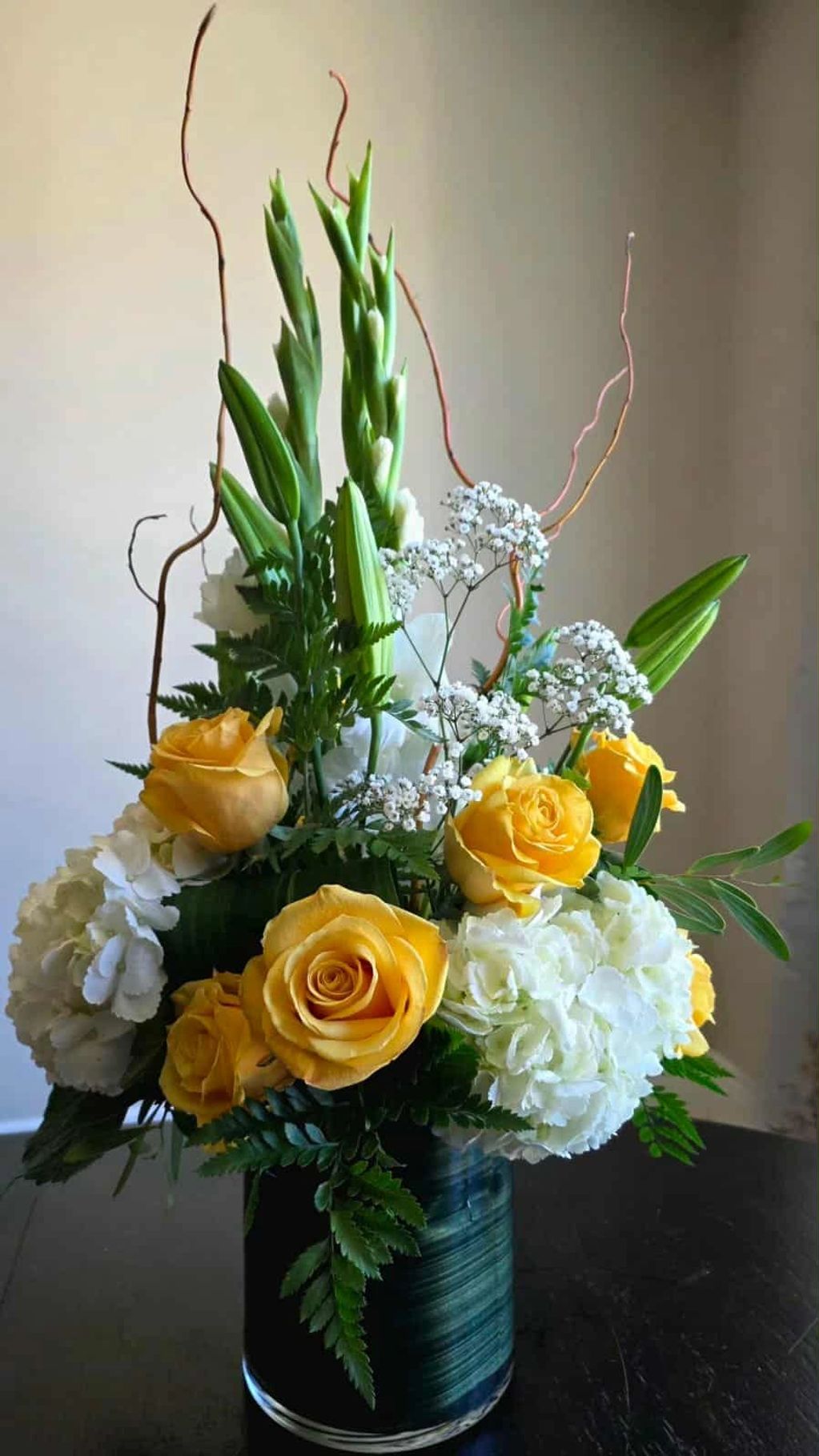 Elegant Sunshine                Priced at $150
Bright yellow roses, soft hydrangeas, and graceful gl