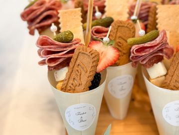 Elegant snack cones with crackers, meats, cheese, and fruits.
