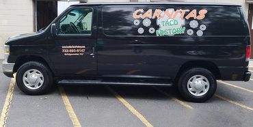 Black van with vinyl lettering.
