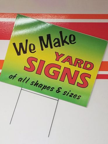 Colorful "We Make Signs" placard.