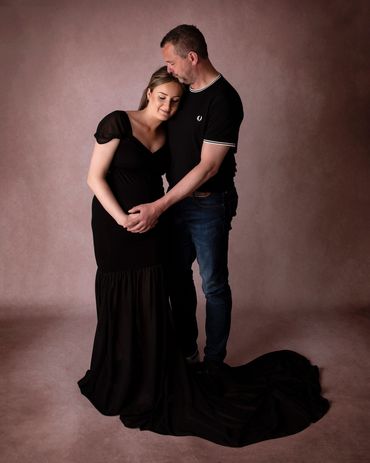 pregnant couple holding each other