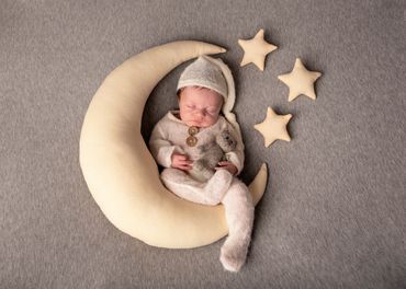 sleeping newborn in the moon
