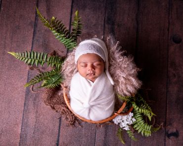 sleeping newborn baby in a basket