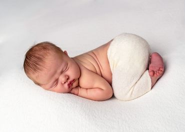 newborn baby sleeping on tummy
