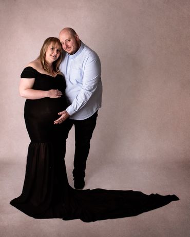 couple holding pregnancy bump