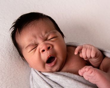 newborn boy yawning