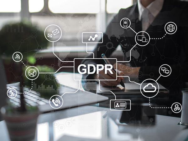Picture with a business person using a graphic tablet in the background, with a GDPR grid on top