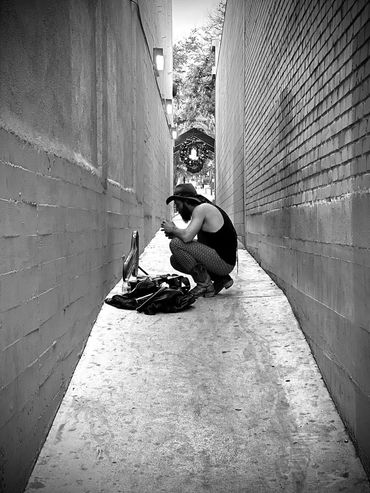 man lighting a cigarette in an alley