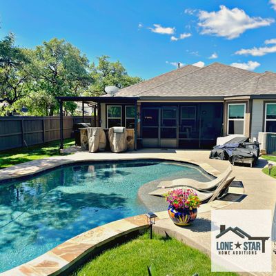 The patio cover and patio enclosure were designed and installed in Helotes, Texas