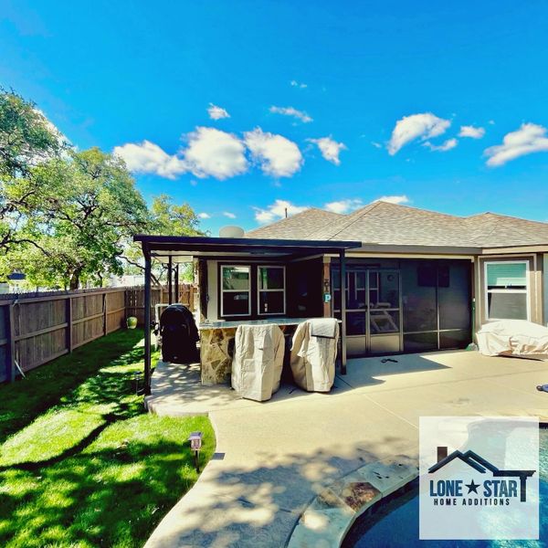 The patio cover and screen room were designed and installed in San Antonio, Texas
