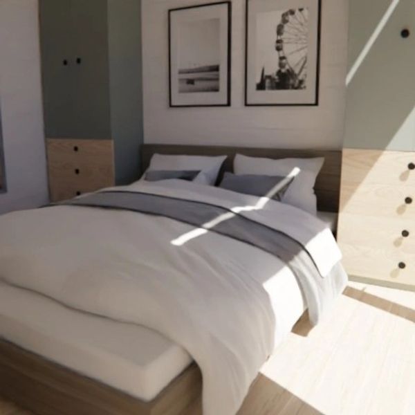 Minimalist bedroom with a cozy bed and framed wall art.