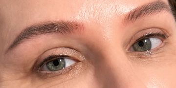 Close-up of green eyes with natural makeup.