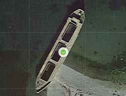 Aerial view of a large shipwreck on a shoreline.