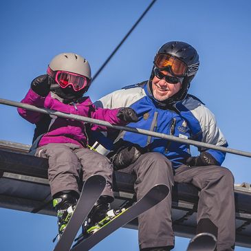 Dad and daughter on ski lift