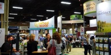 People at a trade show or expo with various booths.