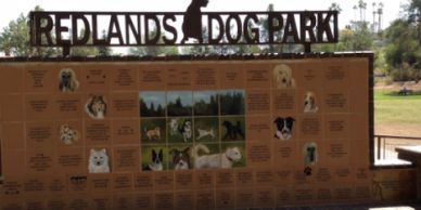 Welcome sign at Redlands Dog Park with pictures of dogs.